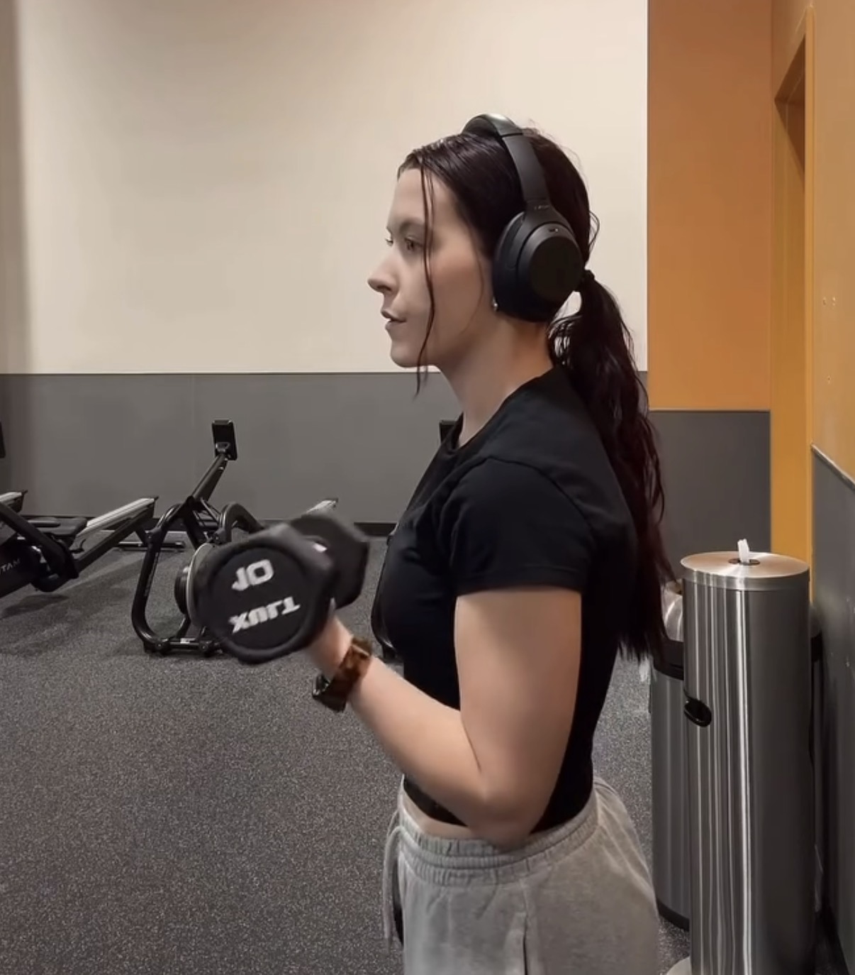 Athlete performing a bicep curl with a dumbbell